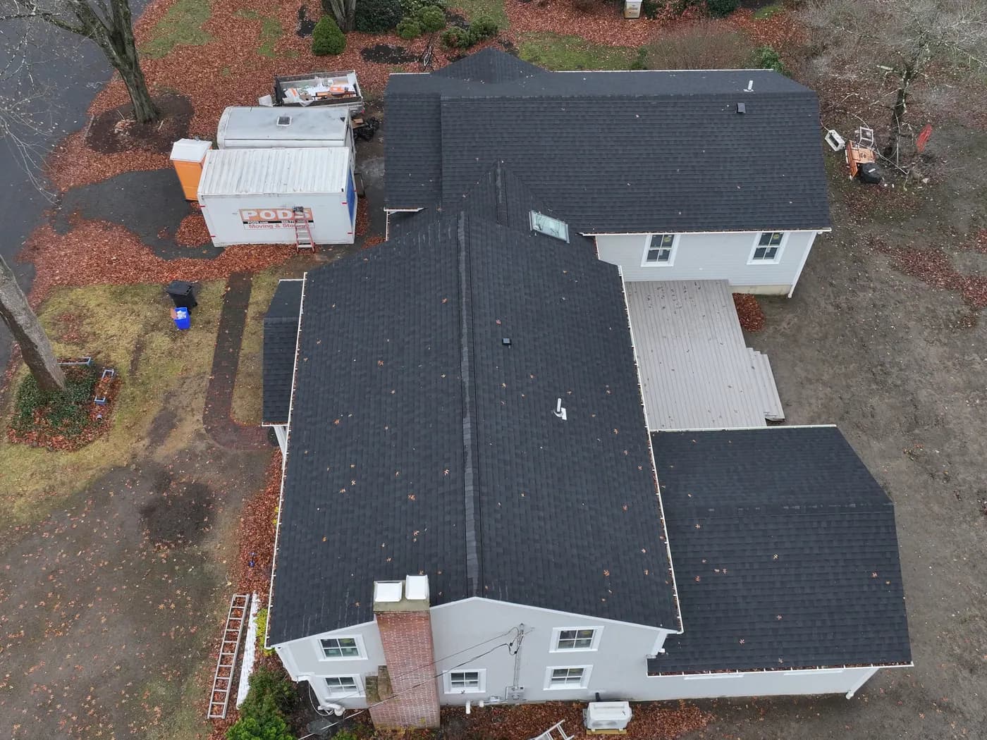Completed asphalt shingle roof replacement by Roofing Doctor, drone view