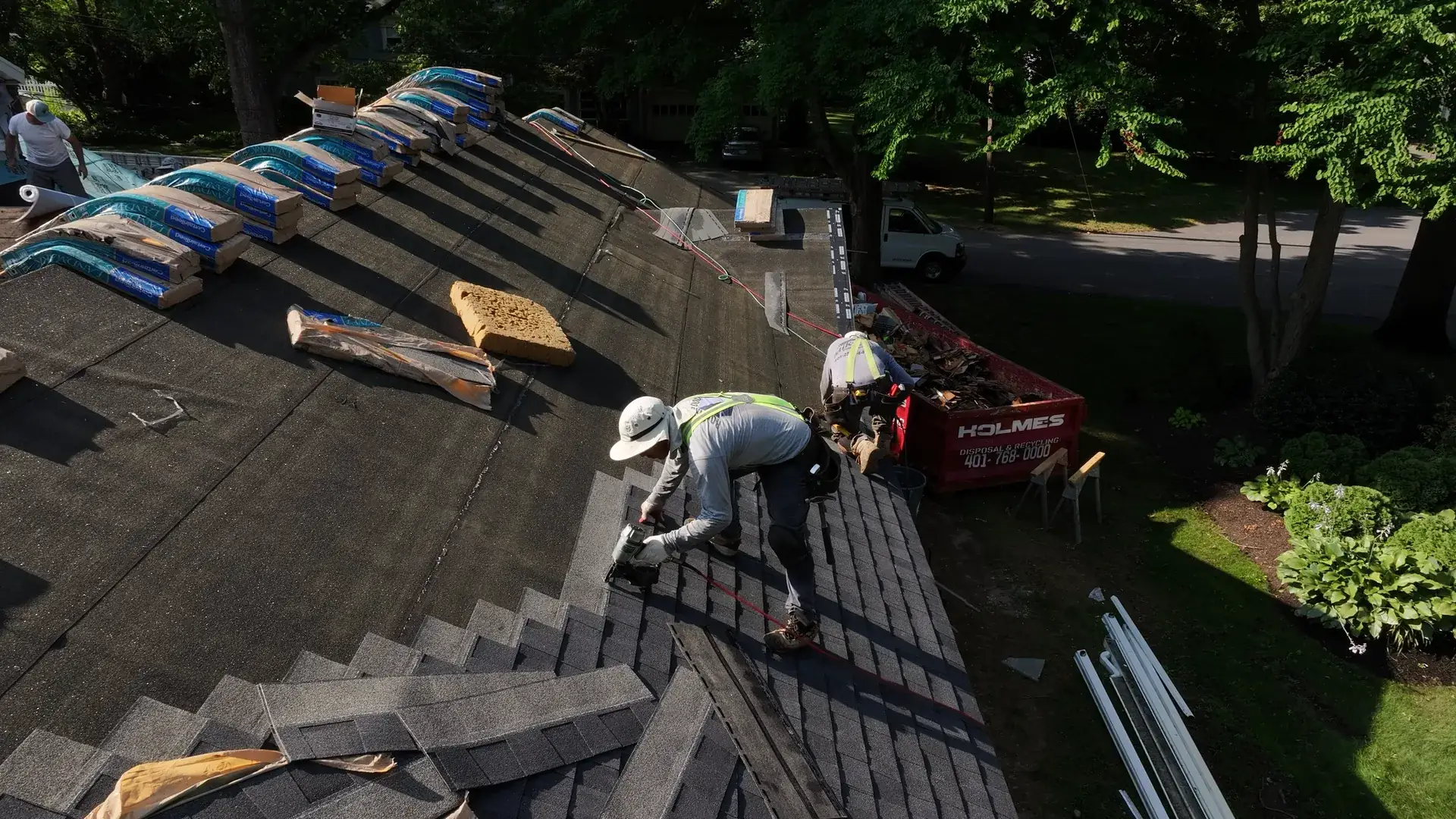Professional roofer installing shingles on a residential roof