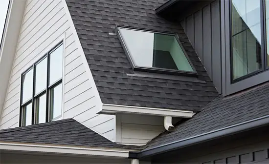 Modern home roofline with several fixed skylights flooding the interior with natural light